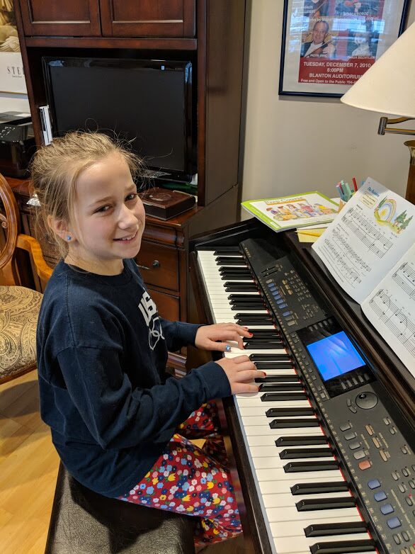 Two students at the piano and violin during individual lessons