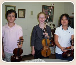 Smiling young violin students