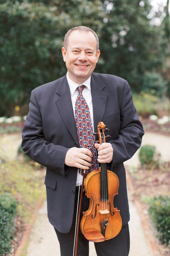 Peter Swic holding his viola